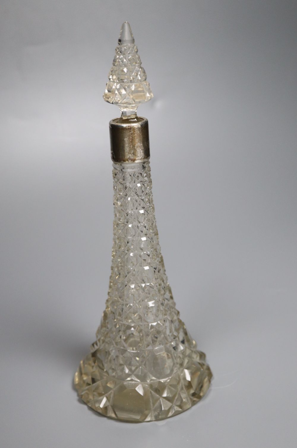 A silver-mounted conical glass scent bottle, sundry other silver-mounted toilet items and an engine-turned silver compact.